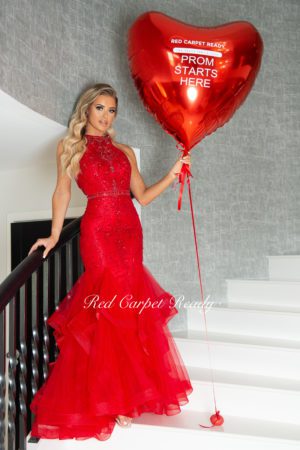 Red sleeveless fishtail dress with a high neckline and sequin embellishments.