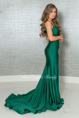 Emerald green bodycon dress with straps and a train.