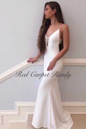 White mermaid dress with a plunging neckline and crystal beading across the chest and straps.