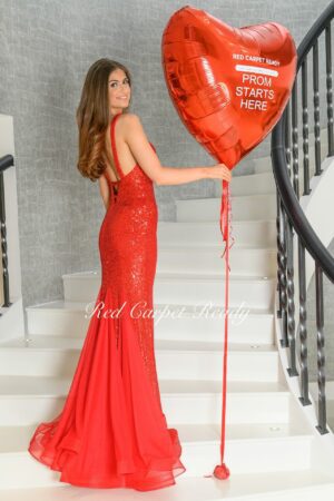 Red mermaid dress with an open back, straps and sequin embellishments.