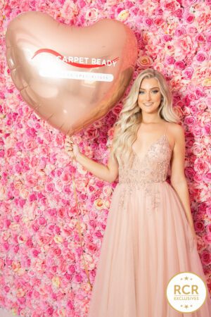 Blush pink a-line dress with sequin detailing, a v-neck and straps.