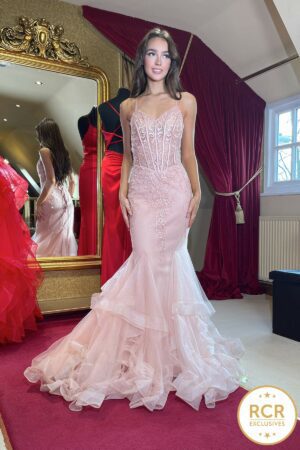 blush fishtail prom dress with a ruffle bottom and a corset bust