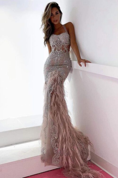 A stunning Couture Feather Gown in stone with intricate embellishments on the bodice.