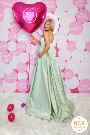 sage satin ballgown with a v-neck, leg split and straps.