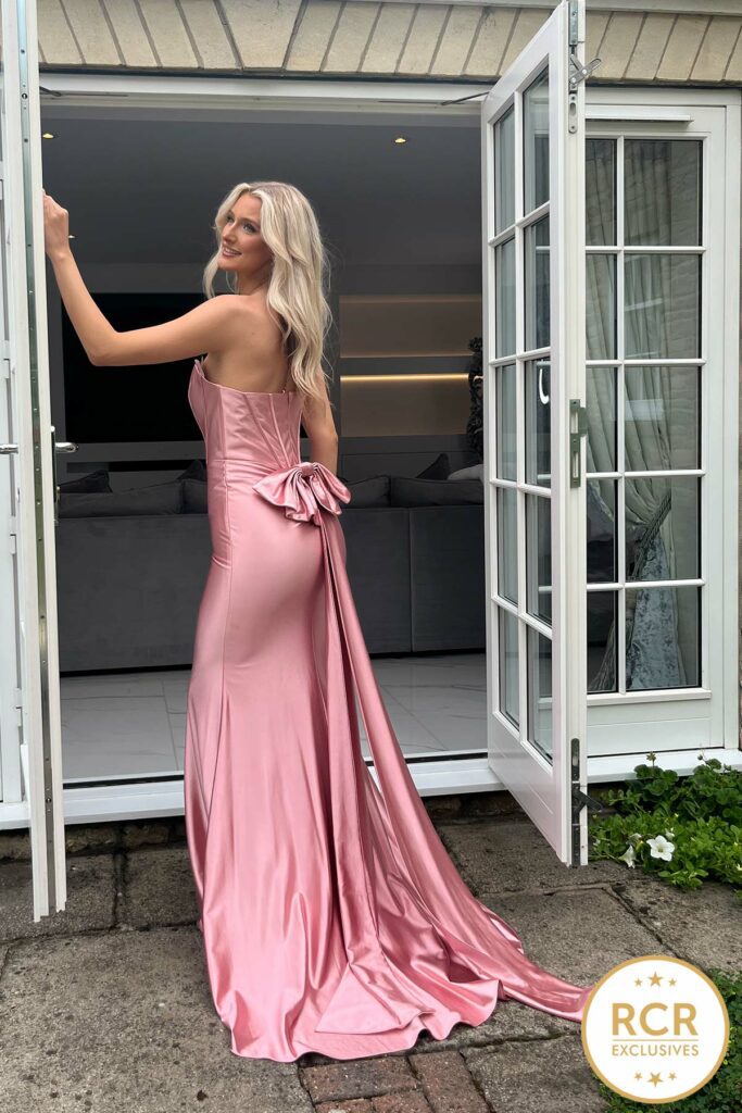 a blush slinky strapless satin gown with detachable bow