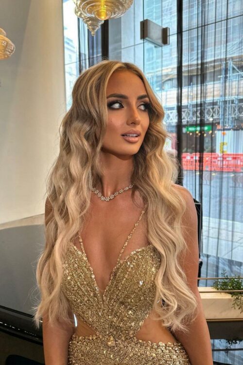 abi moores love island wearing acouture gold prom and evening gown with a leg slit and silver embellished detailing
