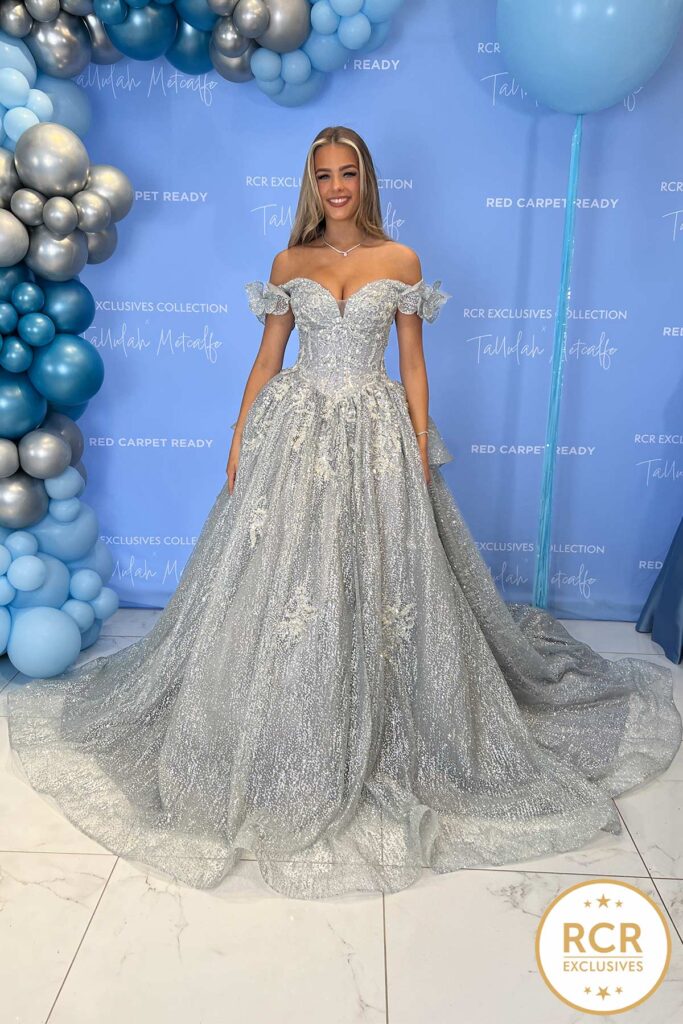 Anastasia is a silver couture ballgown fully embellished with a statement wow trail and with a lace up back.