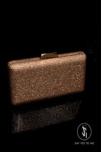 'LUXE' in rose gold is a fully rhinestone-embellished clutch bag that offers a unique glamour and touch of sparkle to any look.