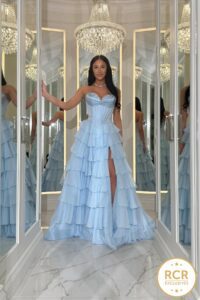 An Ice Blue layered ruffle ballgown prom and eveningwear dress with a high leg slit and a detailed jewel embellished bust