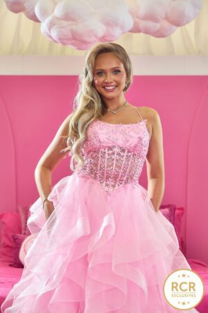 A Sweet pink Princess Prom Dress with tiered ruffles and a beautiful detailed bodice with a corset back.