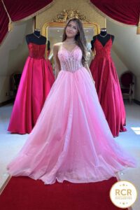 A Sweet Pink Princess Prom Dress with a corset bodice, lace up back and glittery skirt.