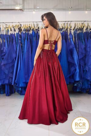 A satin, structured princess ballgown with an open laced back and crystal-encrusted bodice that ombres down the skirt. This dress also has pockets!