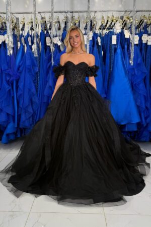 A strapless, off the shoulder black ruffled ballgown prom dress with a corset bodice.