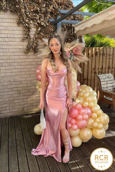 A blush satin prom & evening dress with a statement corset back & deep leg slit, complete with straps.